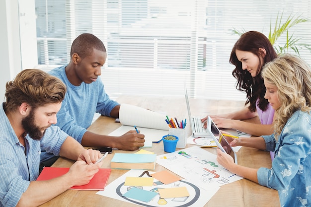 Team collaborating with various planning tools and documents